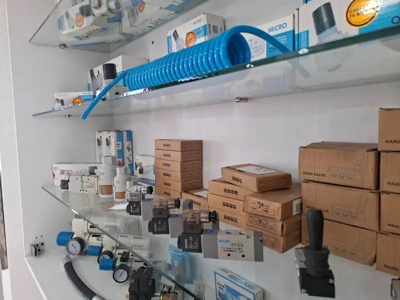 Estante con electroválvulas neumáticas y cajas de repuestos